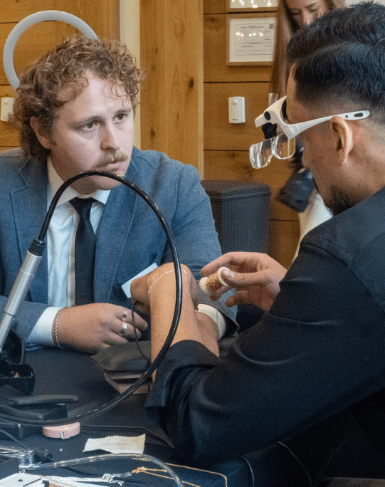 Permanent jewelry being welded during a group event