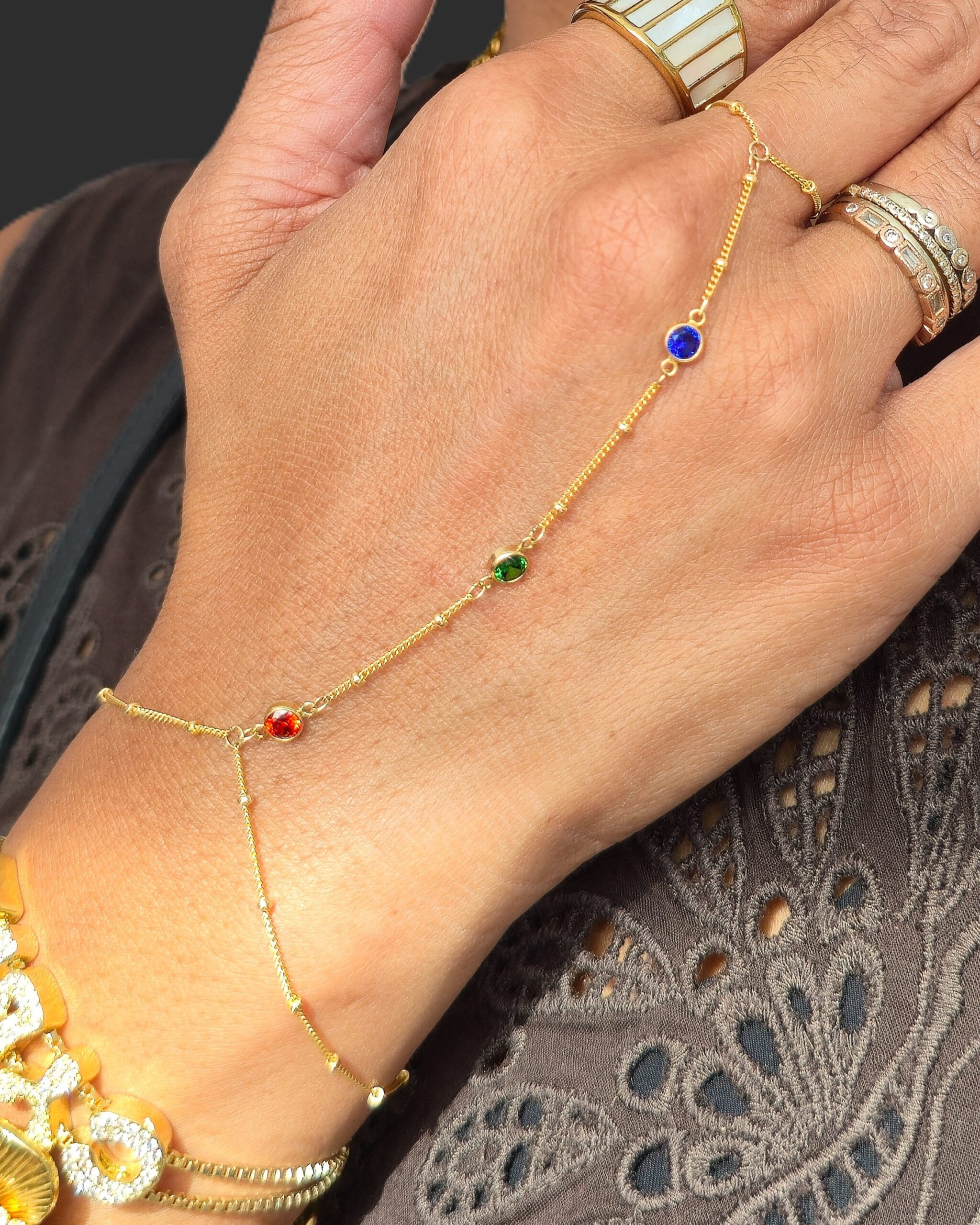 Permanent jewelry hand chain worn across the hand and wrist